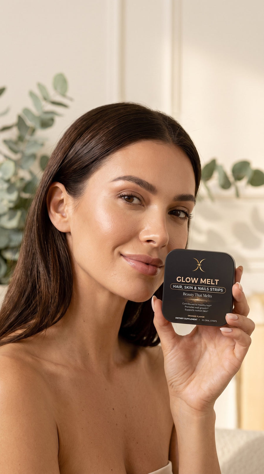 Woman smiling softly with a GLOW MELT tin by her cheek