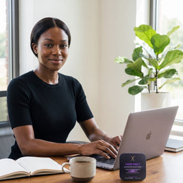 Woman working at a laptop in a bright home office with a MIND MELT tin on the desk